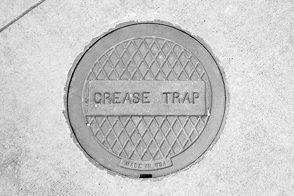 grease trap pumping involves removing and disposing of the accumulated grease and wastewater from the trap